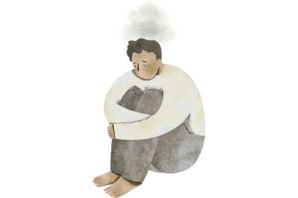 Has it gotten any better, "our education system?" A person sitting curled up, hugging their feet, looking sad and withdrawn.